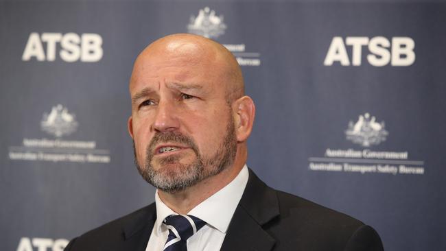 Australian Transport Safety Bureau Chief Commissioner Angus Mitchell reads a preliminary report from its ongoing investigation into the mid-air collision between two sightseeing helicopters over the Broadwater, Gold Coast in January 2023 at a Southport press conference. Picture Glenn Hampson