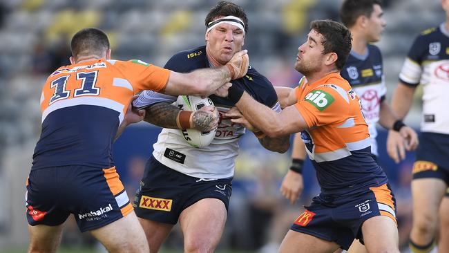 Cowboys forward Josh McGuire is tackled by Lachlan Fitzgibbon and former Broncos teammate Andrew McCullough (right) during their match in Townsville. Picture: Ian Hitchcock/Getty Images