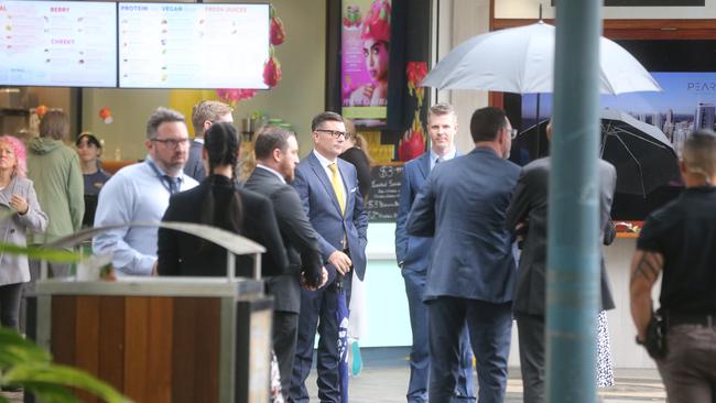 Lawyers and police in Surfers Paradise ahead of the Judge arriving to walk through the crime scene. Picture: by Richard Gosling