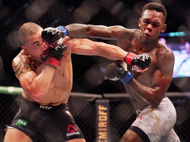 Robert Whittaker of Australia is hit by Israel Adesanya of New Zealand as they compete during UFC 243 at Marvel Stadium in Melbourne. Picture: Michael Dodge