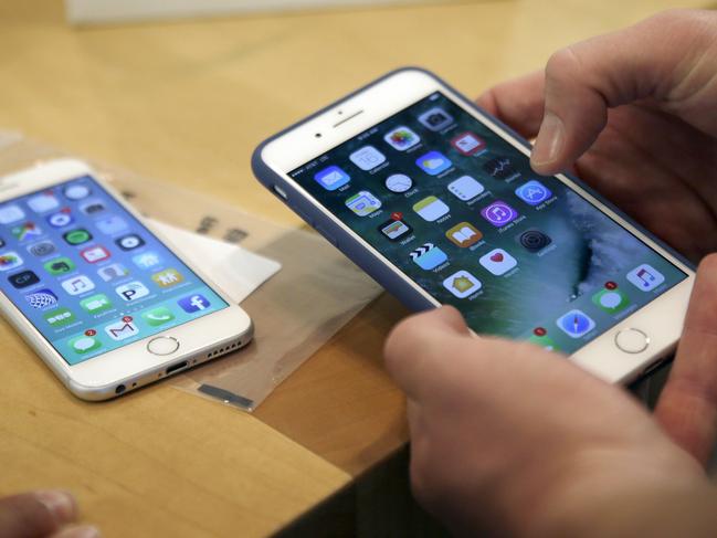 FILE - In this Friday, Sept. 16, 2016, file photo, a customer sets up his new iPhone 7 Plus, right, as he switches from the iPhone 6 at the Apple Store on Michigan Avenue during the release of the Apple iPhone 7 and the latest Apple Watches, in Chicago. New documents from WikiLeaks, posted Thursday, March 23, 2017, point to an apparent CIA program to hack Appleâ€™s iPhones and Mac computers such that the exploits persist even after the devices are reset to factory conditions. Security experts say the exploits are plausible, but they are playing down the threat to typical users. The techniques typically require physical access to devices, something the CIA would only use for individuals it is targeting. (AP Photo/Kiichiro Sato, File)