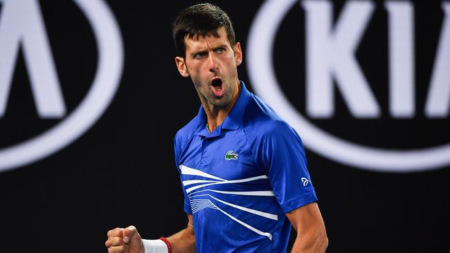 Serbia's Novak Djokovic reacts after a point against France's Lucas Pouille during their men's singles semi-final match on day 12 of the Australian Open tennis tournament in Melbourne on January 25, 2019. (Photo by Paul Crock / AFP) / -- IMAGE RESTRICTED TO EDITORIAL USE - STRICTLY NO COMMERCIAL USE --