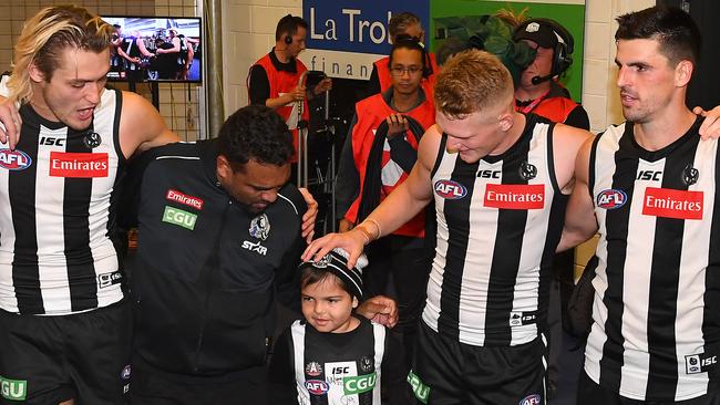 Kyron McGuire with his father and Collingwood heroes. Picture: Getty Images