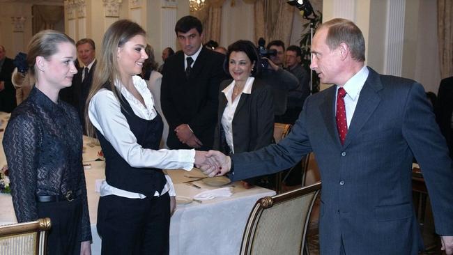 Russian President Vladimir Putin greeting Olympic gymnast Alina Kabaeva, centre, during a meeting in 2004. Picture: Getty Images