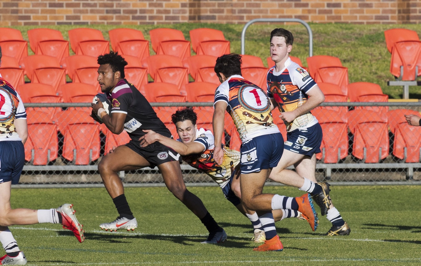 Jeremiah Muld tackled by Angus Wright, St Mary's.