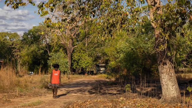 Eshua Brian wanders through his homelands at Buluhkaduru. His family moved to Maningrida for full-time education. Picture: Rebecca Parker