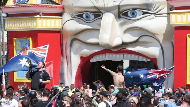 Anti-immigrant protesters in front of Luna Park in St Kilda during the rival Saturday demonstrations in the beach area. Picture: David Crosling/AAP