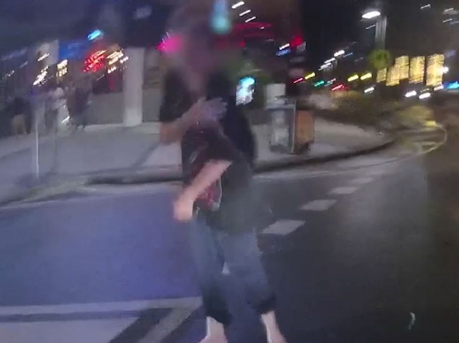 A man reacts after being confronted by police on the Gold Coast.