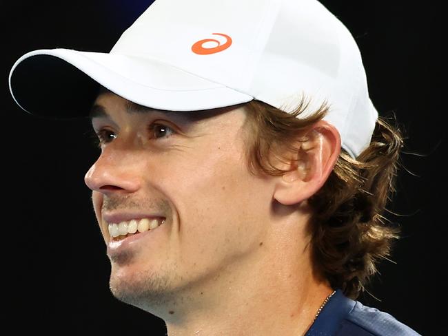 MELBOURNE, AUSTRALIA - JANUARY 08: Alex de Minaur of Australia smiles in his charity match against Carlos Alcaraz of Spain ahead of the 2025 Australian Open at Melbourne Park on January 08, 2025 in Melbourne, Australia. (Photo by Graham Denholm/Getty Images)