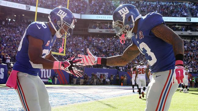 Wide receiver Odell Beckham celebrates with wide receiver Victor Cruz after scoring a 15 yard touchdown.