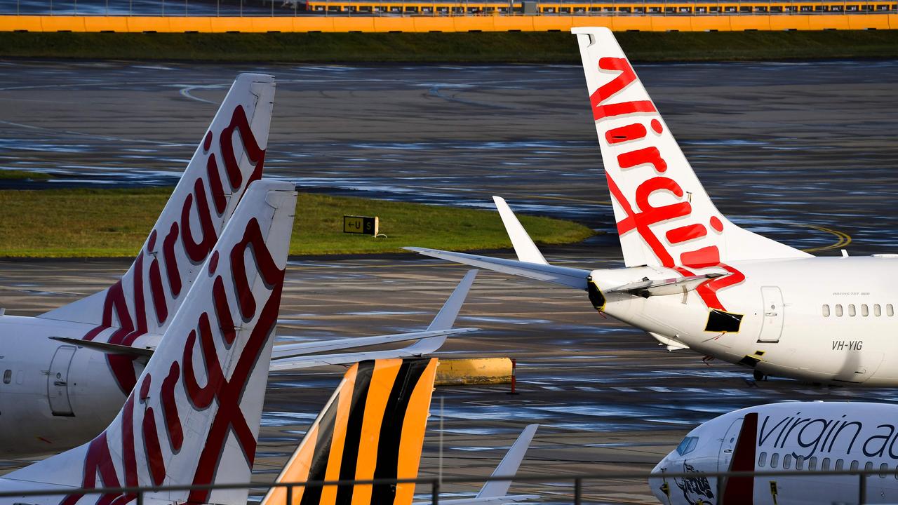 Planes from Australian Airlines Tiger Air and Virgin sit idle on the tarmac at Melbourne's Tullamarine Airport. Picture: William West / AFP