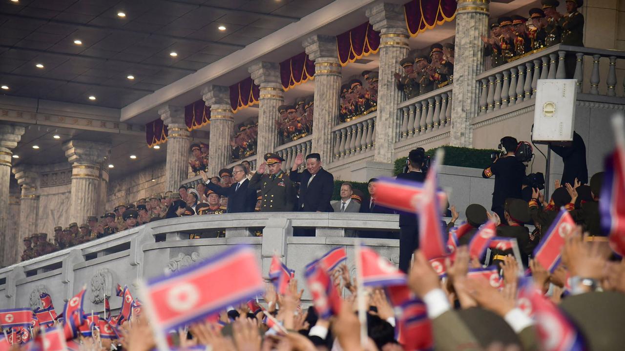 Crowds and dignitaries at the military parade. (Photo by KCNA VIA KNS / AFP).