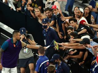 MELBOURNE, AUSTRALIA - FEBRUARY 10: Nick Kyrgios of Australia gives his broken racket to fans after winning his Men's Singles second round match against Ugo Humbert of France during day three of the 2021 Australian Open at Melbourne Park on February 10, 2021 in Melbourne, Australia. (Photo by Mark Metcalfe/Getty Images)