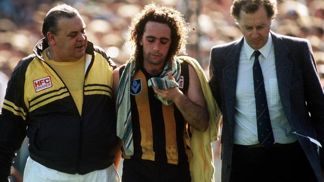 A concussed John Platten is taken back to the Hawthorn rooms.