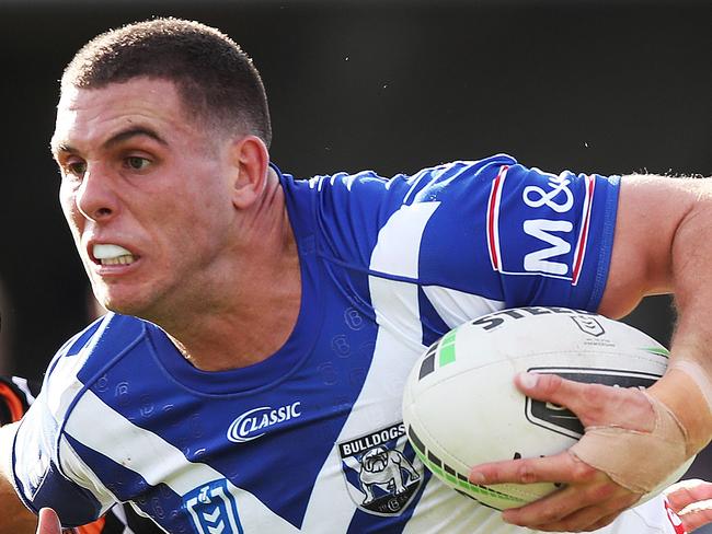 Bulldog's Adam Elliott on his way to score fends off Tiger's Ryan Matterson during NRL match between the Wests Tigers and Canterbury-Bankstown Bulldogs at Campbelltown Stadium. Picture. Phil Hillyard