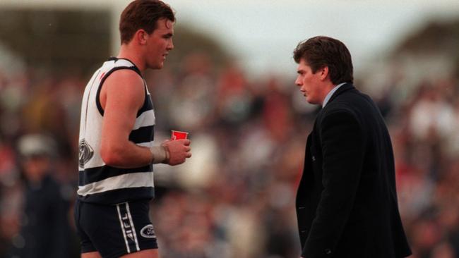 Gary Ayres delivers a message to Cats ruckman Steven King.