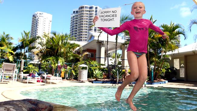 Charlie Bailey leaps into the pool at Main Beach Tourist Park. Picture: Clark David