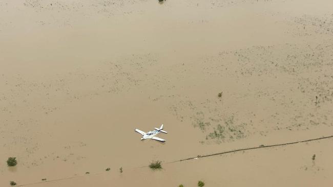 Stations isolated by flooding have welcomed Nautilus Aviation Emergency Service Coordinator Tim Borresen and his crew who have flown in urgent supplies to flooded communities. Here they fly over another aircraft. Picture: Supplied