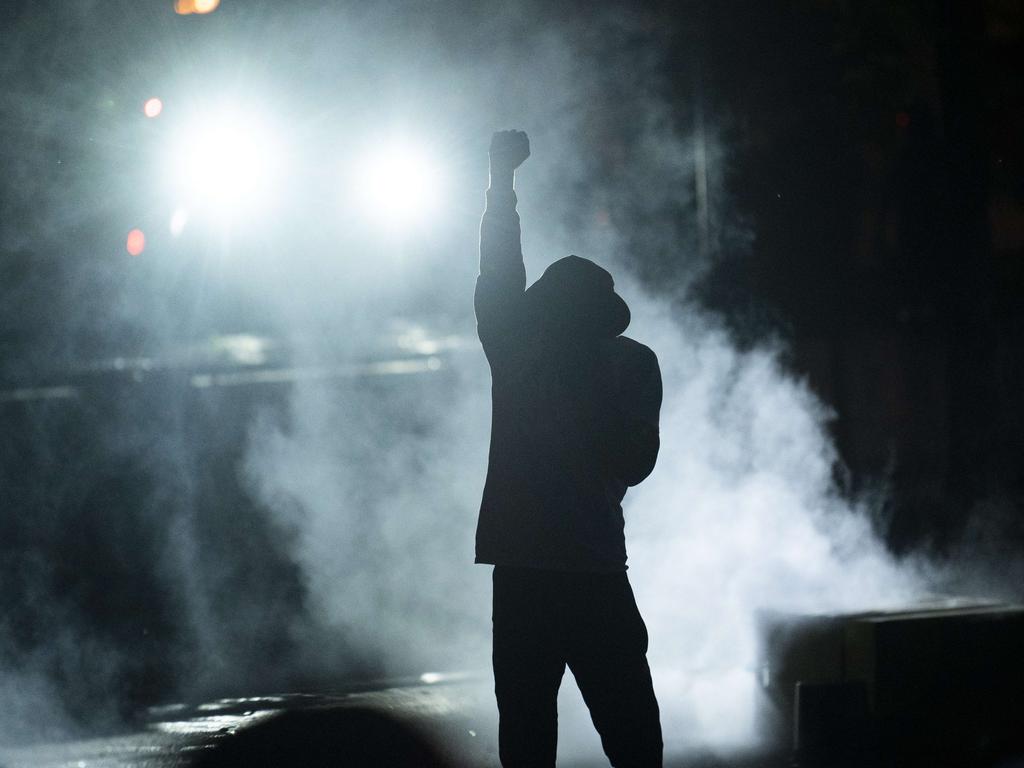 A protester holds up a fist in a cloud of tear gas outside the Third Police Precinct building in Minneapolis, Minnesota. Picture: Stephen Maturen/Getty Images/AFP