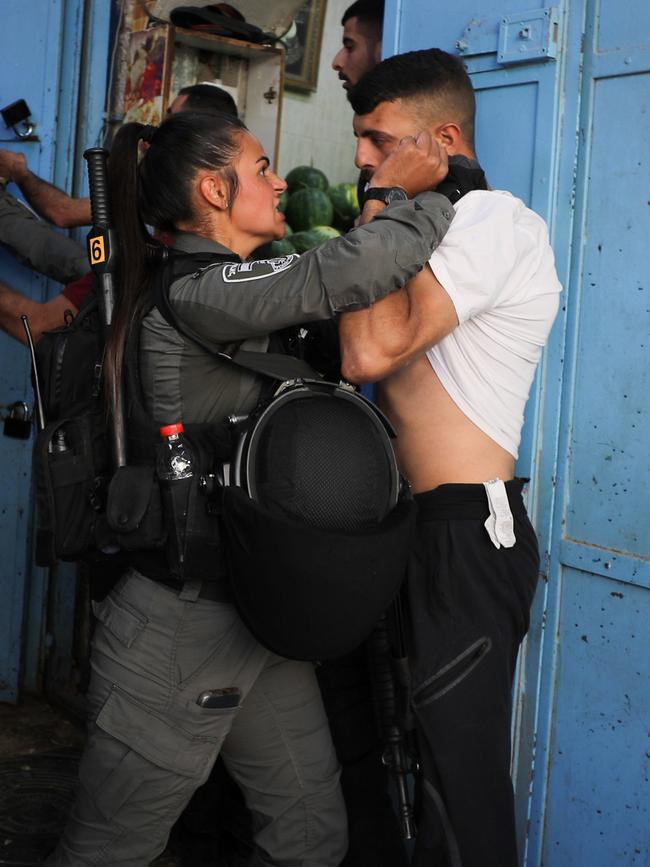 An Israeli security force member holds a protester during a demonstration held by Palestinians. Picture: REUTERS/Ammar Awad