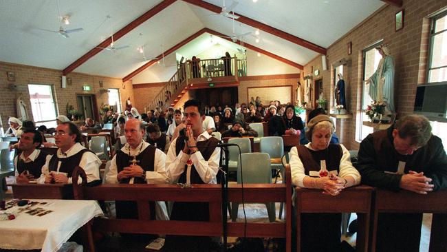 Leader William Kamm (2nd from L) with followers at Order of St Charbel’s sect headquarters in Nowra. NSW.