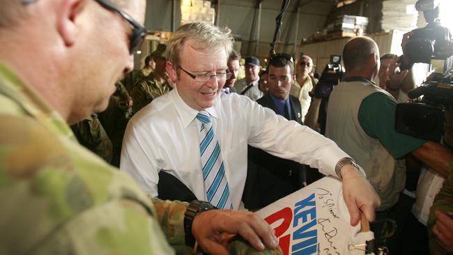 Then-Prime Minister Kevin Rudd signing a Kevin 07 shirty shortly after taking office.