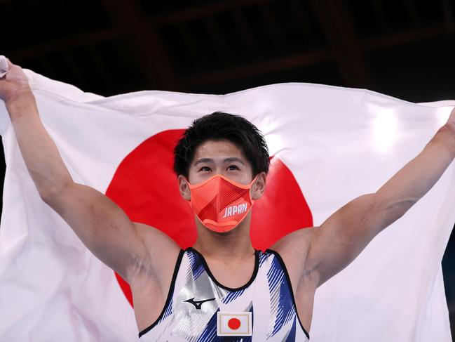 Daiki Hashimoto of Team Japan celebrates his victory with the Japan Flag during the Men's All-round Final. Picture: Laurence Griffiths/Getty Images)