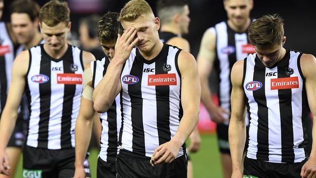 Adam Treloar of the Magpies reacts (centre) after the Round 15 AFL match between the Collingwood Magpies and the North Melbourne Kangaroos at Marvel Stadium in Melbourne, Saturday, June 29, 2019. (AAP Image/Julian Smith) NO ARCHIVING, EDITORIAL USE ONLY