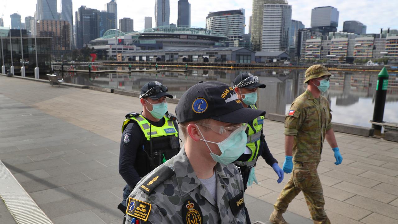 Police and Australian Defence Force officers patrol Docklands in Melbourne during the city’s stage 4 lockdown. Picture: David Crosling/NCA NewsWire