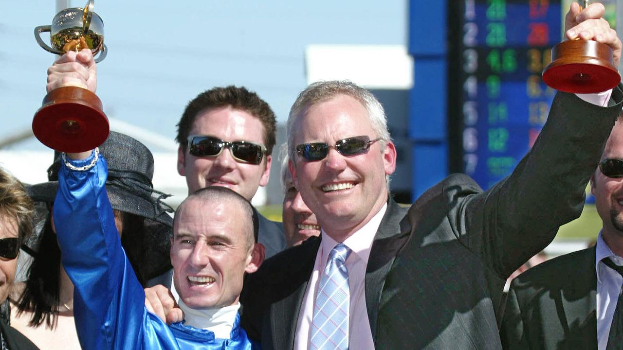 NOVEMBER 4, 2003 : Trainer David Hall & jockey Glen Boss hold respective trophies aloft at Flemington following victory in Melbourne Cup with racehorse Makybe Diva 04/11/03. Pic Michael Dodge.
Turf / Trophy