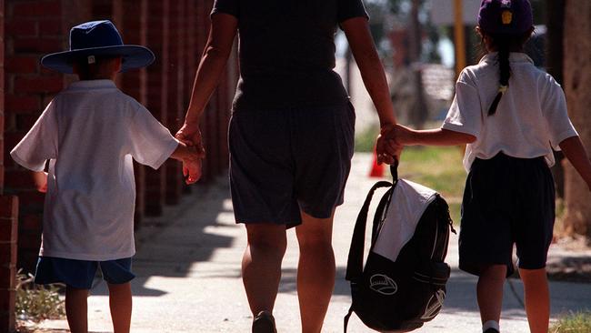 Feb 18, 2000 : Generic photo of primary school students in Perth on way home with mother,   PicRoss/Swanborough. WA / Education / Student situation families walking hand in hand