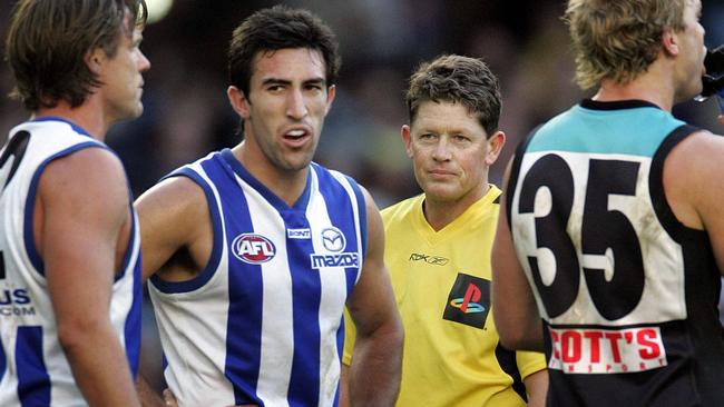 Brett Allen umpires a match between North Melbourne and Port Adelaide.