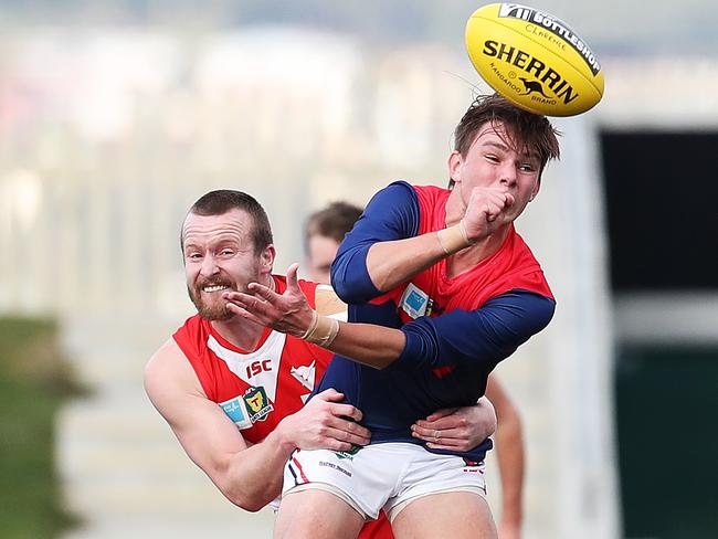 Baxter Norton handballs under pressure from Clarence’s Jeromey Webberley during his previous stint with North Hobart. Picture: NIKKI DAVIS-JONES