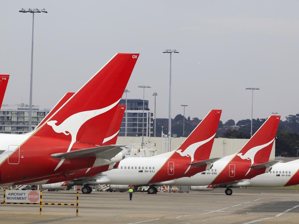 The tails of Qantas planes are lined up at Sydney Airport in Sydney, Sunday, Oct. 30, 2011. Qantas Airways grounded all of its aircraft around the world indefinitely Saturday due to ongoing strikes by its workers. (AP Photo/Rick Rycroft)