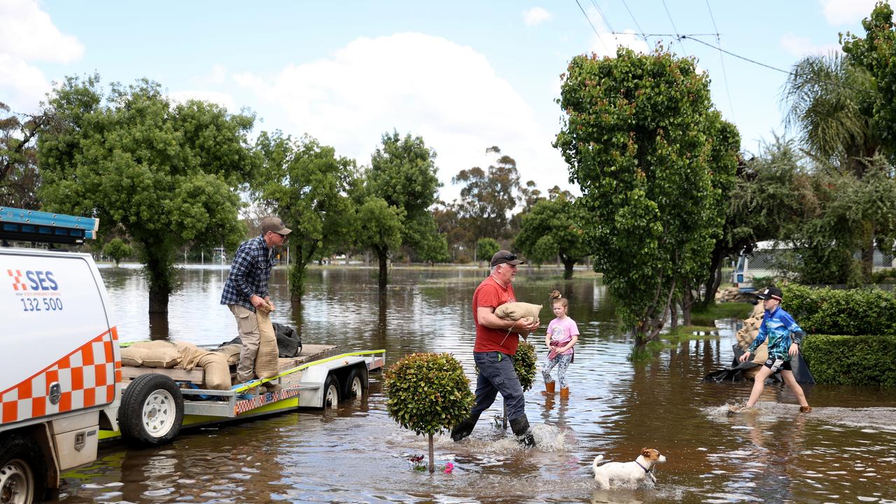 People carry sandbags through flood waters in Forbes, NSW last week. Picture: Brendon Thorne / Getty Images / POOL / NCA NewsWire