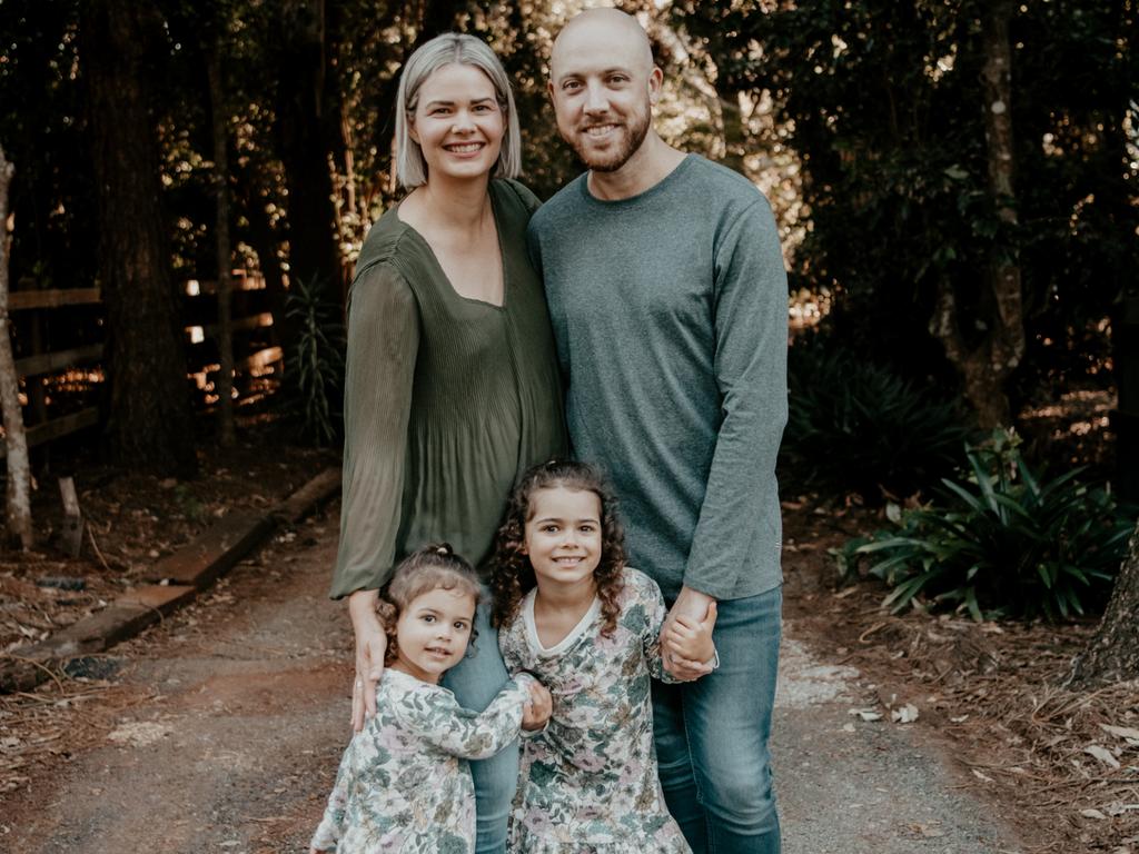 Amy Crisafulli, 35, with husband Dan, 36, and two girls Eliza, 5, and Adalyn, 3, of the Gold Coast. The couple say expensive childcare fees have played a major part in not having a third child. Credit: Zoe Rane Photography.