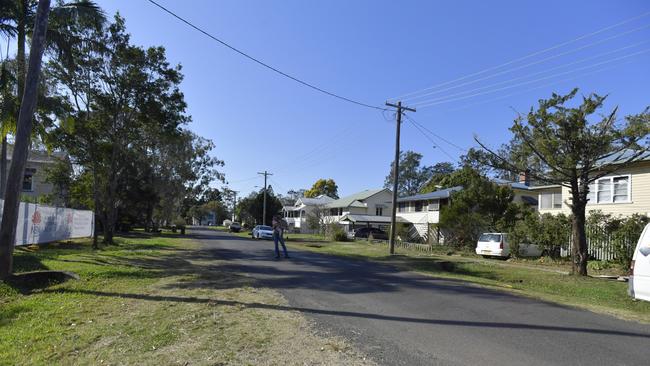 South Lismore resident Cappy Hardaker in the middle of Charles St, South Lismore. He says residents on the right have been snubbed while those on the left have generally been offered help.