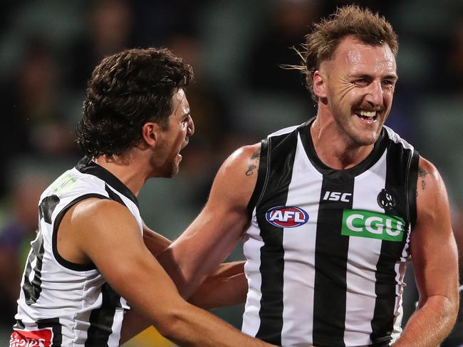 ADELAIDE, AUSTRALIA - AUGUST 11: Lynden Dunn of the Magpies celebrates a goal with team mate Josh Daicos during the 2020 AFL Round 11 match between the Adelaide Crows and the Collingwood Magpies at Adelaide Oval on August 11, 2020 in Adelaide, Australia. (Photo by Matt Turner/AFL Photos via Getty Images)