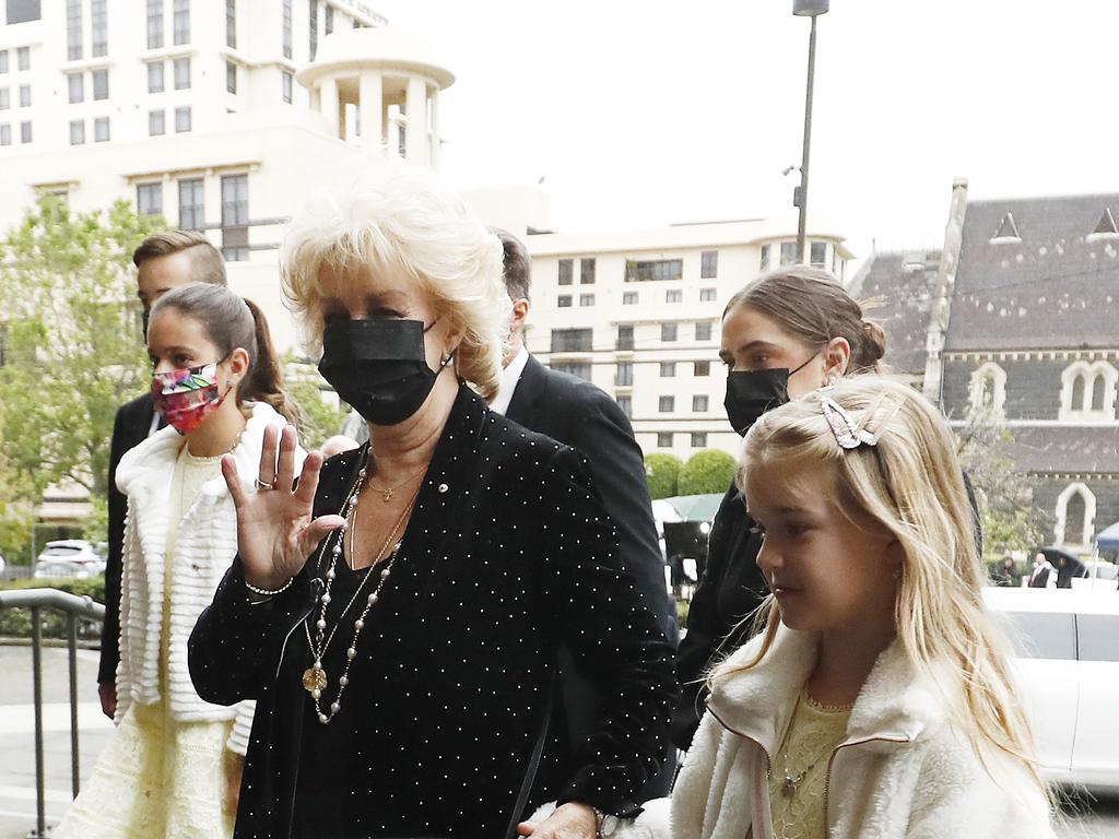 Patti Newton waves to the camera as she arrives at St Patrick's Cathedral. Picture: Darrian Traynor/Getty Images