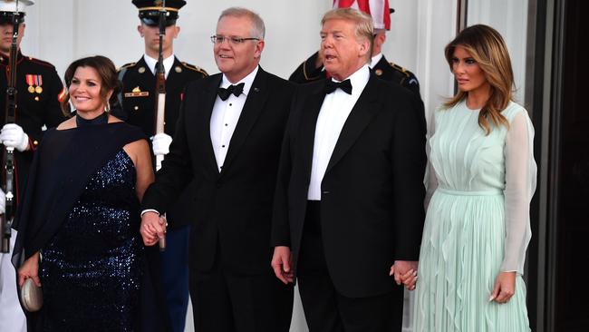 President Donald Trump and wife Melania wearing Us designer J Mendel, with Prime Minister Scott Morrison and wife Jenny, wearing Carla Zampatti. Picture: AAP