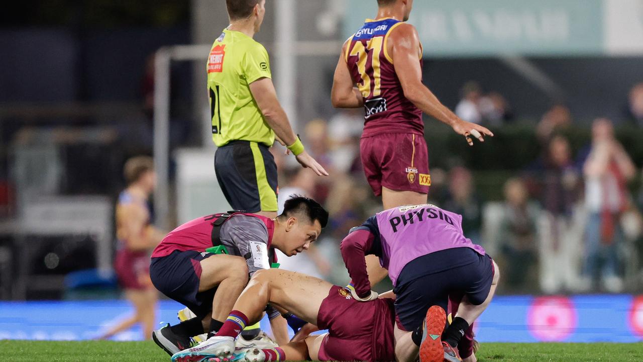 BRISBANE, AUSTRALIA - JULY 22: Will Ashcroft of the Lions lays injured on the ground during the 2023 AFL Round 19 match between the Brisbane Lions and the Geelong Cats at The Gabba on July 22, 2023 in Brisbane, Australia. (Photo by Russell Freeman/AFL Photos via Getty Images)