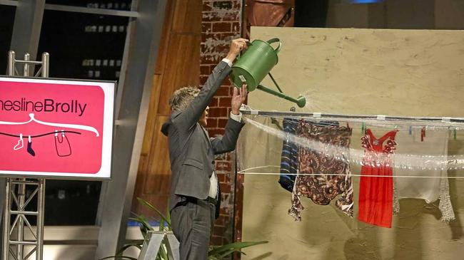 Shark Tank&#39;s Andrew Banks tests out Liana Wynne&#39;s Clothesline Brolly.