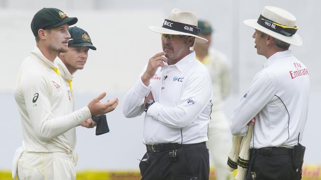 Umpires Nigel Llong and Richard Illingworth question Australian fieldsman Cameron Bancroft during day three of the third Test against South Africa in Cape Town last year. Picture: Getty Images 