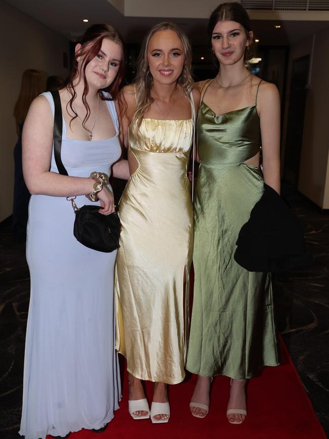 MELBOURNE, AUSTRALIA – JUNE 14 2024 Caitlin Meal, Tanesha Johnson and Madison Maher attend the Lowanna College Senior Formal 2024 at the Moe Racing Club Picture: Brendan Beckett