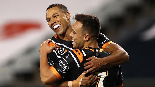 Former Queensland Origin utility Moses Mbye (left) has been given permission to negotiate with rival clubs by the Wests Tigers.