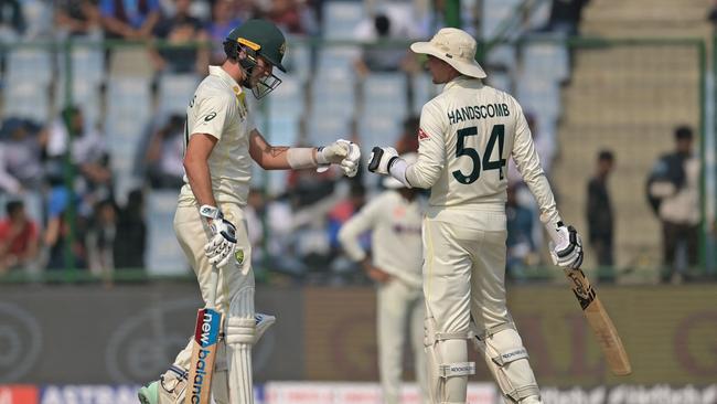 Australia's captain Pat Cummins (L) and Peter Handscomb.