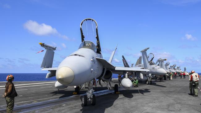 Sailors assigned to the Nimitz Carrier Strike Group perform pre-flight checks. Picture: US Navy