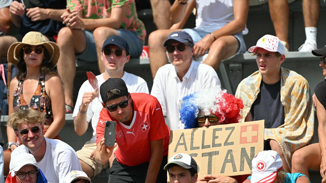 Fans of Switzerland's Stan Wawrinka cheer him on in his men's singles second round tennis match against Alexei Popyrin. Picture: Miguel Medina/AFP