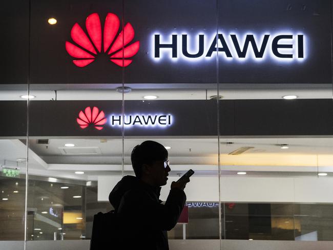 BEIJING, CHINA - JANUARY 29: A pedestrian talks on the phone while walking past a Huawei Technologies Co. store on January 29, 2019 in Beijing, China. The U.S. Justice Department filed a host of criminal charges against Chinese telecoms giant Huawei and its chief financial officer, Meng Wanzhou, including bank fraud, violating sanctions on Iran, and stealing robotic technology. Huawei denied committing any of the violations and rejected criminal claims against Meng, the daughter of Huawei founder Ren Zhengfei, who was arrested in Canada in December last year. (Photo by Kevin Frayer/Getty Images)