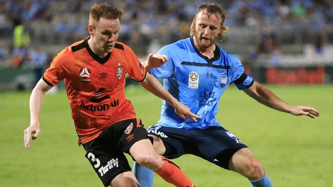 Roar’s Corey Brown tries to give slip past Rhyan Grant. Picture: Getty Images